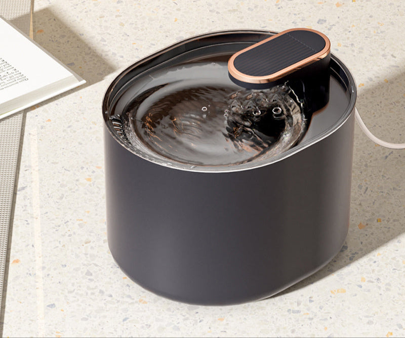 Automatic pet water fountain in dark gray with a copper-accented pump.